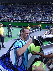 David Nalbandian and fans at the 2006 Australian Open. Nalbandian signing autographs at 2006 Australian Open.jpg