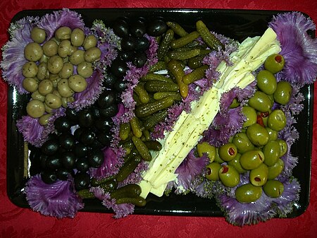 Olives attractively served in purple cabbage leaves.jpg