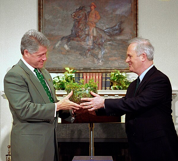 Bruton (right) giving a bowl of shamrocks to US president Bill Clinton on Saint Patrick's Day, 1995