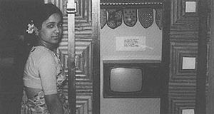 An ISRO technician next to a working model of the solid-state television set, designed with NASA assistance, for use in SITE. Image courtesy NASA SITE ISROwoman.jpg