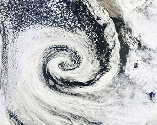 A clockwise spinning low-pressure area or cyclone of southern Australia. The center of the spiral-shaped cloud system is also the center of the low.