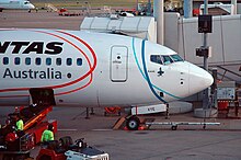 Qantas Boeing 737 with Commonwealth Games livery; Karak is visible near the nose. VH-VYE 'Karak' Boeing 737-838 Qantas sporting the Melbourne 2006 Commonwealth Games Livery (9003329938).jpg