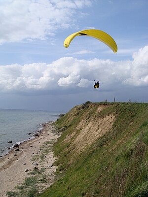 Yellow paraglider in flight (9 May 2009).jpg