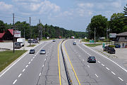 An urban expressway segment of King's Highway 11 in Severn, Ontario. Note the driveway access immediately preceding the exit ramp.