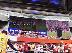 The video screen, showing subtitles and a BSL interpreter for 'Abide with Me' at Wembley Stadium at the 2023 Challenge Cup Final