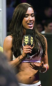 AJ Lee holding a microphone addressing the crowd