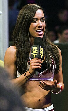 AJ Lee holding a microphone addressing the crowd