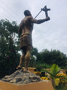 Denis Ssebugwawo Monument with the symbol of his faith and the instrument of his martydom A cross and a spear, Denis Ssebugwawo Monument.jpg