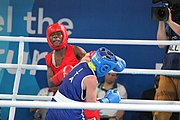 Deutsch: Boxen bei den Olympischen Jugendspielen 2018 Tag 12, 18. Oktober 2018 - Finale Fliegengewicht Mädchen – Martina La Piana (Italien, blau) schlägt Adijat Gbadamosi (Nigeria, rot) 5-0; Ringrichter ist James Beckles (Trinidad und Tobago). English: Boxing at the 2018 Summer Youth Olympics on 18 October 2018 – Girl's flyweight Gold Medal Bout - Martina La Piana (Italy, blue) beats Adijat Gbadamosi (Nigeria, red) 5-0; Referee is James Beckles (Trinidad and Tobago). Español: Boxeo en los Juegos Olímpicos Juveniles de Verano de 2018 en 18 de octubre de 2018 - Combate a medalla de oro de peso mosca para mujeres: Martina La Piana (Italia, azul) le gana a Adijat Gbadamosi (Nigeria, roja) 5-0; El árbitro es James Beckles (Trinidad y Tobago).