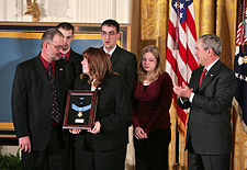 President George W. Bush presents the Medal of Honor to the family of Jason Dunham during a ceremony in the East Room on January 11, 2007