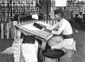 A batik maker with batik stempel to work in a state of batik manufavturing in Tanah Abang, cir. 1910-1930