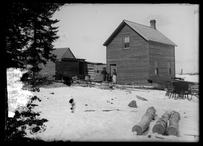 File:Couple standing beside their home (I0052828).tif