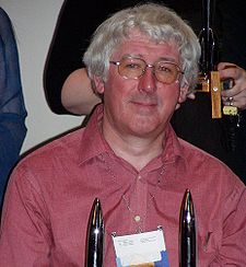 David Langford at Worldcon 2005 in Glasgow, with two Hugo Awards.