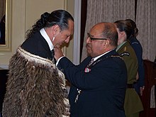 Investiture of Derek Lardelli as ONZM by Governor-General of New Zealand Sir Anand Satyanand for services to Maori arts at a ceremony at Government House, Wellington in September 2008 Derek Lardelli ONZM investiture.jpg