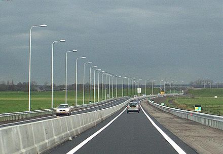 Single carriageway expressway that was economically upgraded to (mostly) meet the new Regional flow road standard. A physical traffic barrier, and a hard shoulder were added.