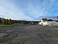 Looking west across the coach parking area, entrance building on the right