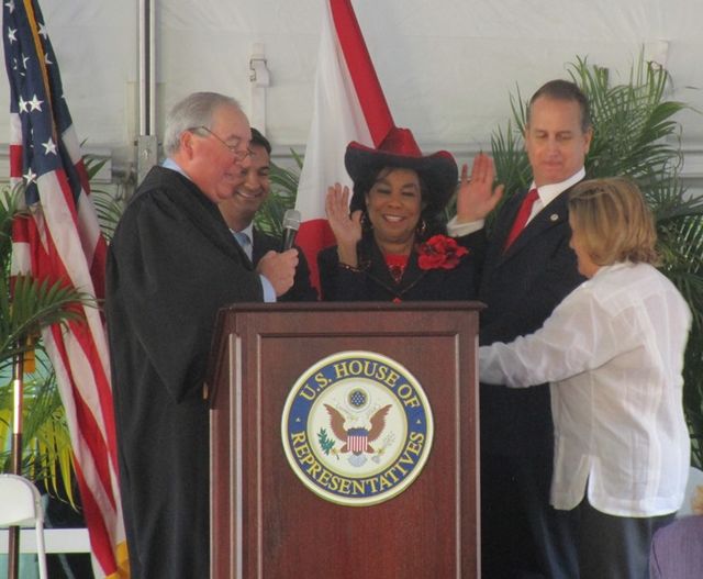 Ros-Lehtinen (right) being sworn in as a member of Congress by Chief Judge Kevin Michael Moore (left), along with Florida colleagues Carlos Curbelo, F