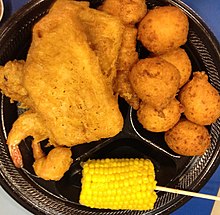 A dish of fried shrimp, fish, corn on the cob, and hushpuppies Gfp-chicken-fish-corn-hushpuppies.jpg