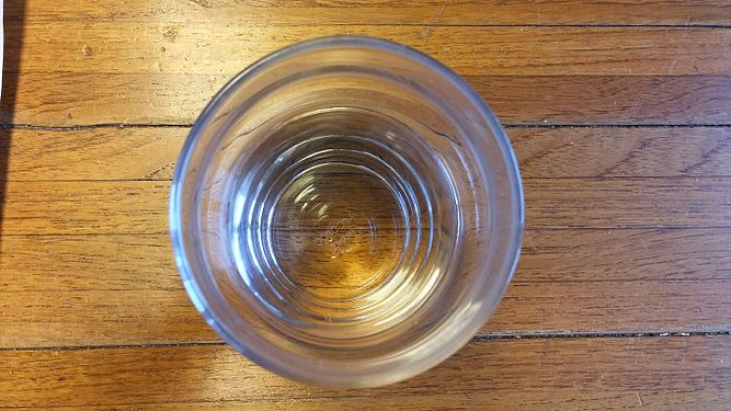 Glas on wooden table from above