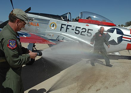 Greg Anders sprays his father with the fire hose after completing his last flight in 2008