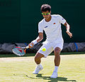 Hiroki Moriya competing in the first round of the 2015 Wimbledon Qualifying Tournament at the Bank of England Sports Grounds in Roehampton, England. The winners of three rounds of competition qualify for the main draw of Wimbledon the following week.