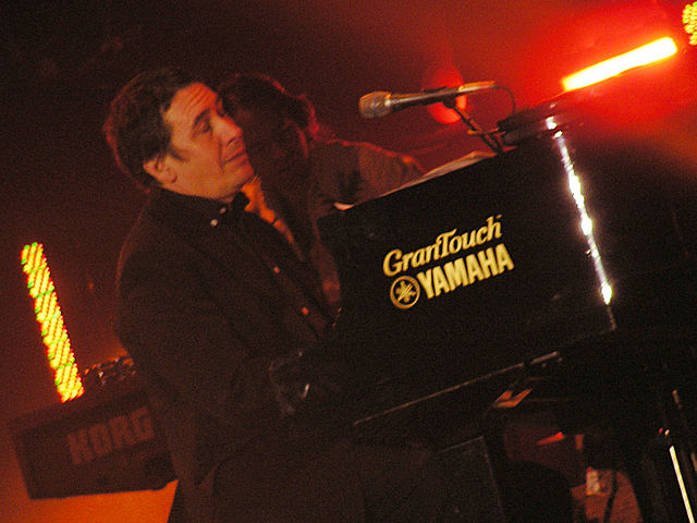 Jools Holland playing a piano on stage