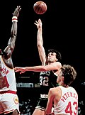 Hakeem Olajuwon and Jim Petersen surround Kevin McHale (who would 25 years later become Houston's coach) during the 1986 NBA Finals. Lipofsky-Kevin McHale.jpg