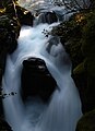 Long exposure of water passing by an obstinate rock (4139070129).jpg