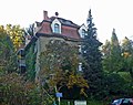 Residential house in open development, with a park-like garden