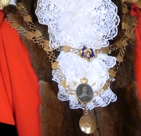 Mayor's Chain of Office, Mayor of South Molton, made in 1893, from which hangs a miniature portrait of Hugh Squier (died 1710), the town's "great benefactor". Above is an enamelled coat of arms of the Borough of South Molton: Azure, a bishop's mitre in chief a sheep's fleece or MayoralChain SouthMolton Devon.PNG
