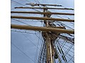 folding up the topsail of the mainmast