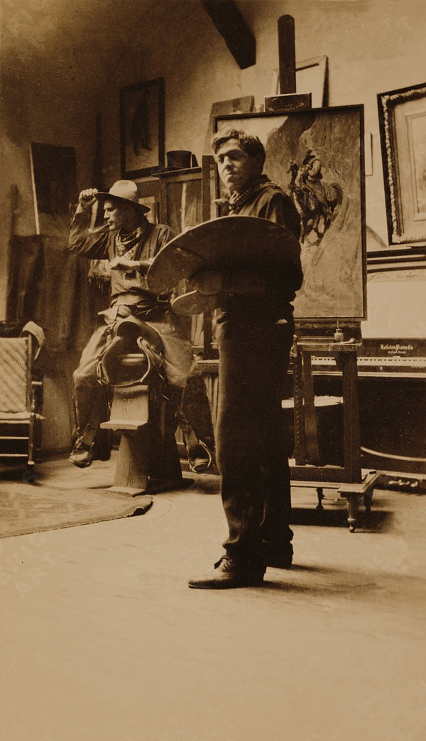 N. C. Wyeth in his studio with a cowboy model