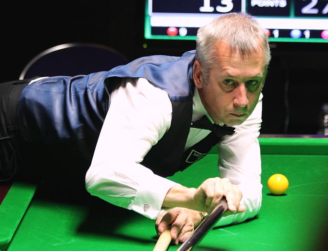 Nigel Bond (pictured in 2016) defeated Liang Wenbo 5–4 in a closely contested match and progressed to the second round