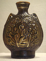 Northern Qi jar with olive green glaze with Central Asian dancer and musicians 550 577.jpg