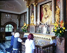 The veneration of images of Mary is called Marian devotion (above: Lithuania), a practice questioned in the majority of Protestant Christianity. Ostrabrama-prayer.jpg