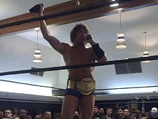Kenny Omega with the PWG World Championship belt