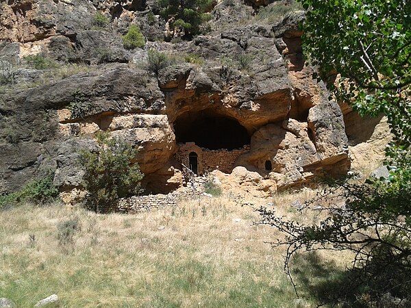 Middle Age livestock shelter or paridera in a natural cave in Piedra River in the monk's old path from the monastery to the roe deer salt ponds, Arago