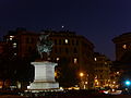 Italiano: Piazza Corvetto a Genova al sopraggiungere del buio. In Primo piano la statua a Vittorio Emanuele II, sopra i palazzi al centro della foto uno spicchio di Luna