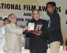Pranab Mukherjee presenting the Rajat Kamal Award for Best Child Artist (Shared) Fandry Meengal (Marathi) to Somnath Avghade, at the 61st National Film Awards function, in New Delhi. The Secretary.jpg