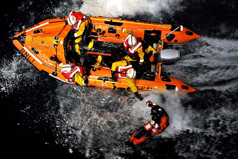 File:RNLI Lifeboat Crew Reaching Out to Royal Navy Rescue Winchman MOD 45153646.jpg