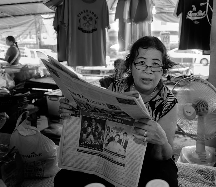 File:Reading woman, Mae Phim market. Thailand (23520474102).jpg