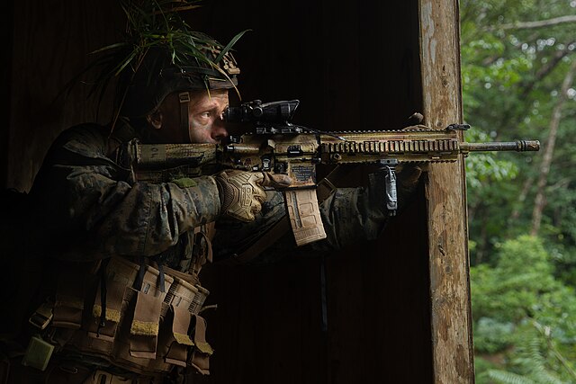 U.S. Marine Corps Lance Cpl. Eric Kassow, a rifleman with 3d Marine Division, provides security during the 3d Marine Division Rifle Squad Competition 