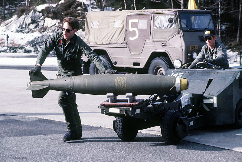 File:Sgt. Jim Hendricks steadies an- Mark 82 bomb being carried by a bomb loader to an F-16 Fighting Falcon aircraft for loading DF-ST-82-07192.jpg