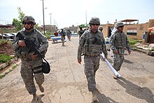 Soldiers from 214th Military Police (MP) Company, Alabama Army National Guard, march towards Tal Kayf Police Station in Tal Kayf district of Mosul, Iraq, May 3, 2011. U.S. Soldiers from 214th Military Police (MP) Company, Alabama Army National Guard, march towards Tal Kayf Police Station, to speak with local Iraqi Police officers concerning a training exercise in Tal Kayf 110503-A-RH393-010.jpg