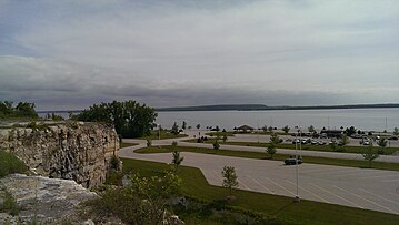 View to the southwest across Sturgeon Bay to Cabot Point in the Idlewild area (background, right) and the bluff at Potawatomi State Park (background, center) from the Old Stone Quarry in Sevastopol; much of the quarry is now George K. Pinney County Park