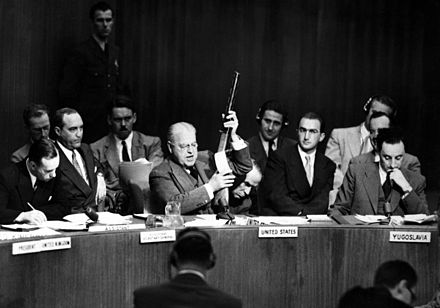 Austin demonstrates a captured Soviet-made submachine gun to the United Nations Security Council in 1951, to demonstrate Soviet support for North Korea during the Korean War.