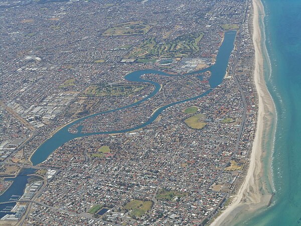 An aerial photo of the north-western suburbs of Adelaide. Delfin Island has an irregular shape and can be seen in the centre