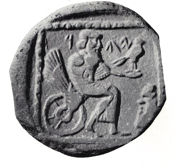 A 4th-century BCE silver coin from the Persian province of Yehud Medinata, possibly representing Yahweh enthroned on a winged wheel. This identificati