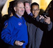 NASA astronaut John M. Grunsfeld with Ahmed Mohamed at the 2015 White House Astronomy Night. 2015 White House Astronomy Night by Harrison Jones 06 (cropped).jpg