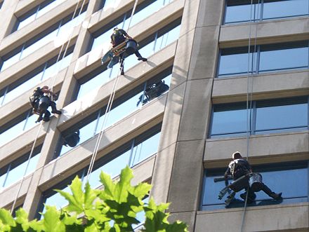 Three high-rise window cleaners at work
